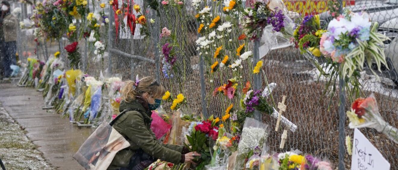 Mourners leave flowers at the site of domestic terrorism attack at a supermarket in Boulder, Colorado.