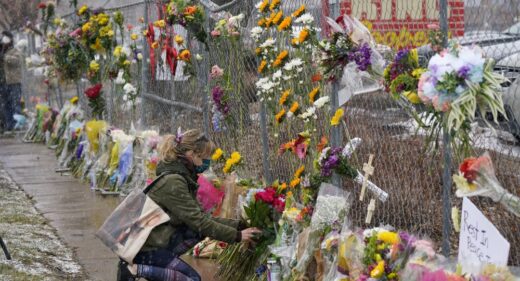 Mourners leave flowers at the site of domestic terrorism attack at a supermarket in Boulder, Colorado.