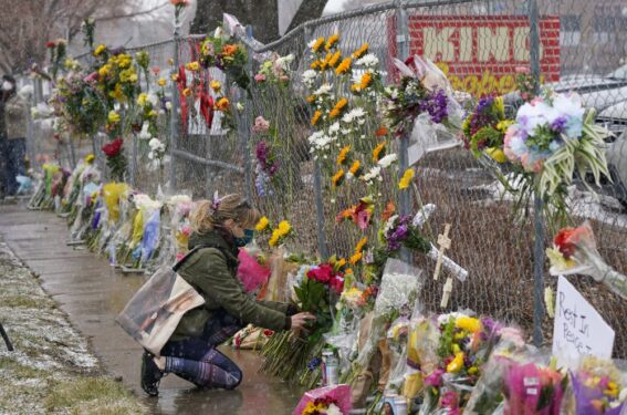 Mourners leave flowers at the site of domestic terrorism attack at a supermarket in Boulder, Colorado.