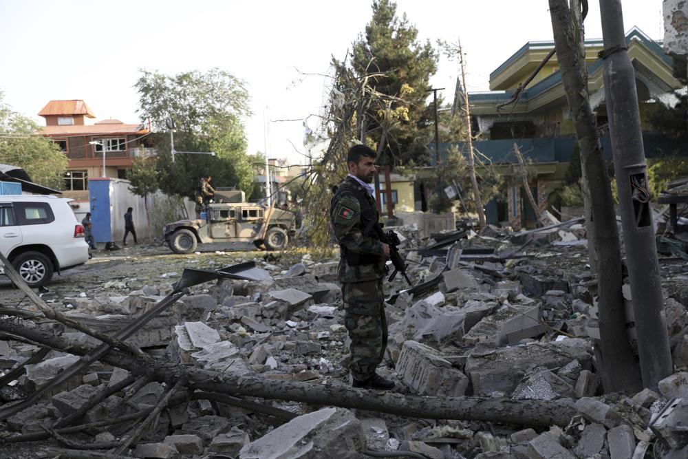 An Afghan security person stands amid debris from a damaged building following an attack that apparently targeted the country s acting defense minister - Blog