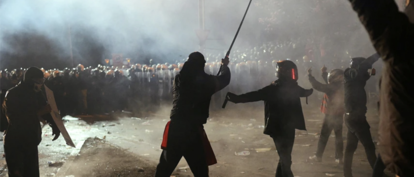 Turkish police face demonstrators in Istanbul during clashes after opposition arrest